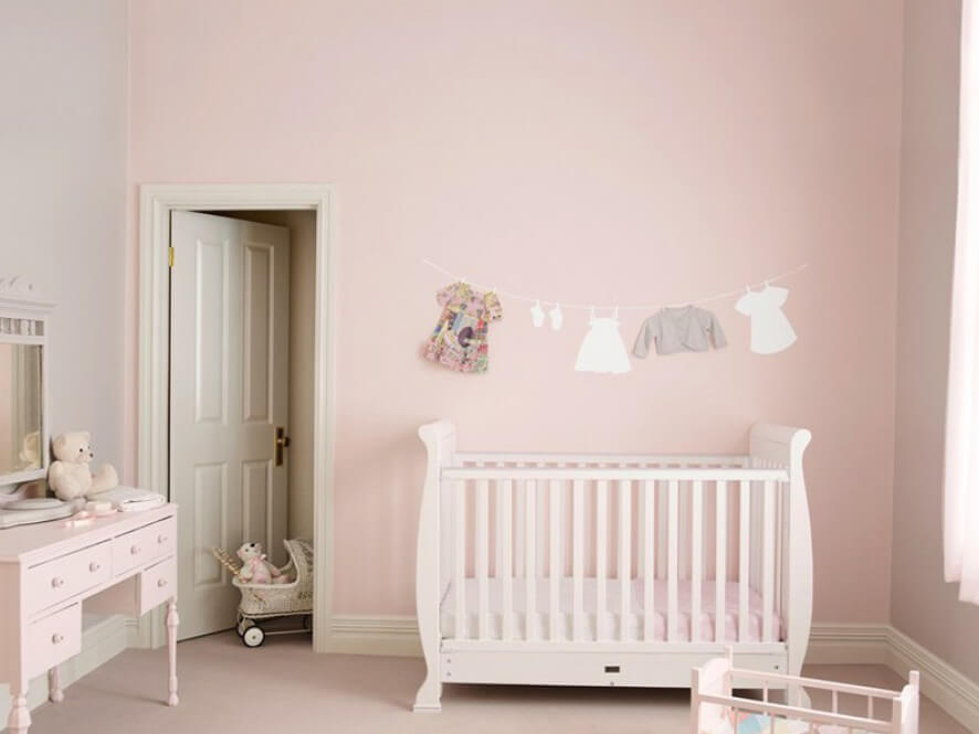 pink_nursery_feature_wall_cream_door_clothesline_artwork_white_cot_pink_carpet_dressing_table